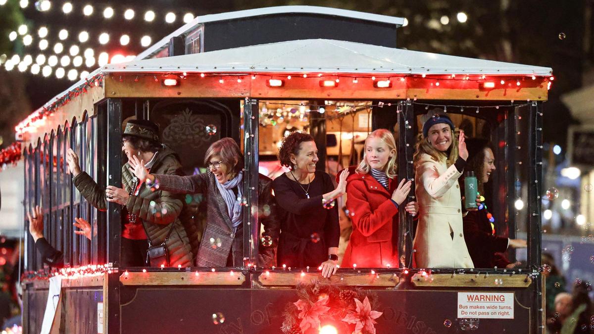 The SLO City Council rides on the trolley at the 47th Annual Downtown Holiday Parade in San Luis Obispo on Dec. 1, 2023.