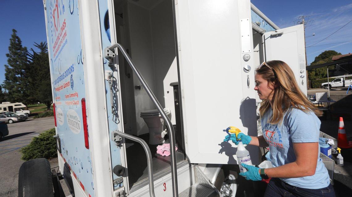 Volunteer Emily Francis sanitizes a shower after a client’s shower. A portable program called “Shower the People,” helps homeless connect with services Oct. 25., 2022 at Unitarian Universalist Church near Meadow Park.