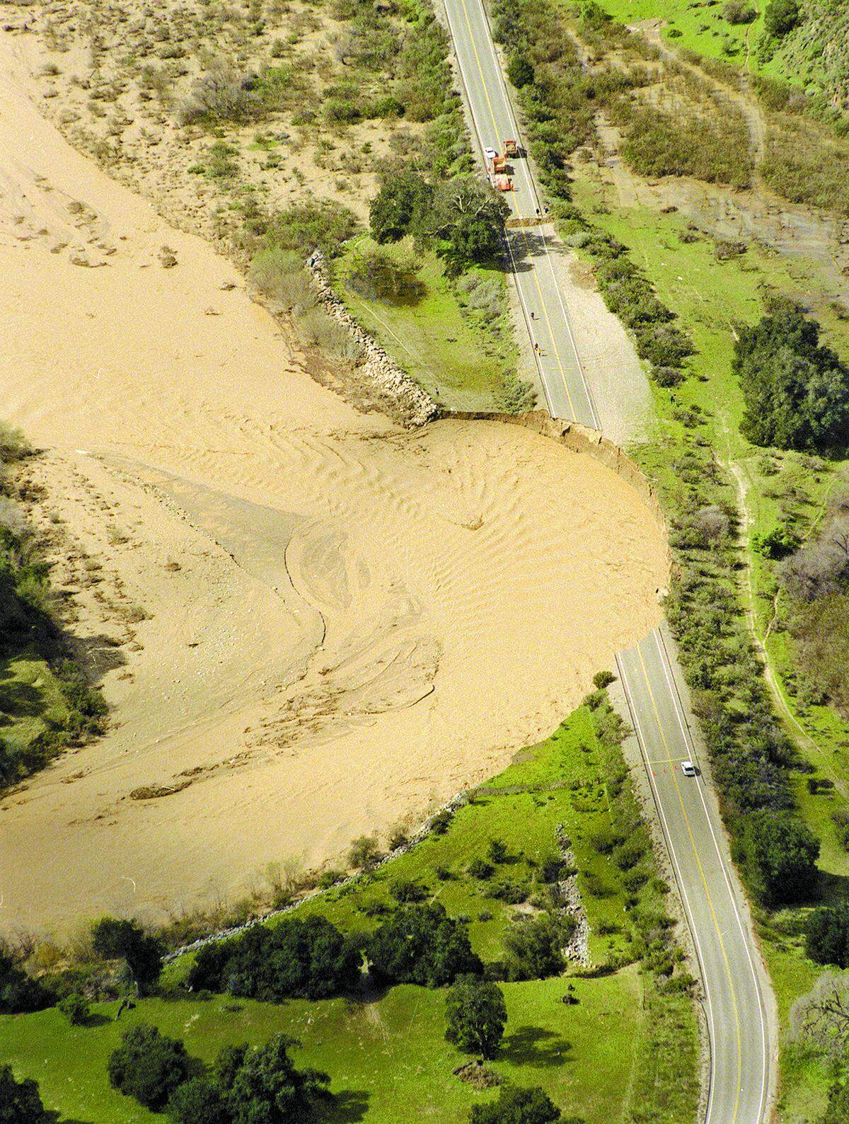 A section of Highway 166 collapsed 12 miles east of Highway 101 after being gouged out by the Cuyama River in February 1998. Three people, including two CHP officers, were killed when their cars plunged into the water.