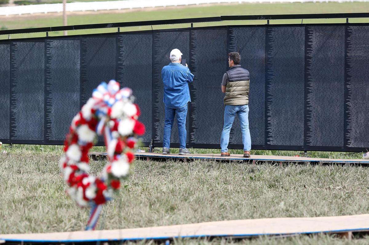 Two people visit The Wall that Heals, a traveling replica of the Vietnam Veterans Memorial in Washington, D.C., in San Luis Obispo on Saturday, March 18, 2023.