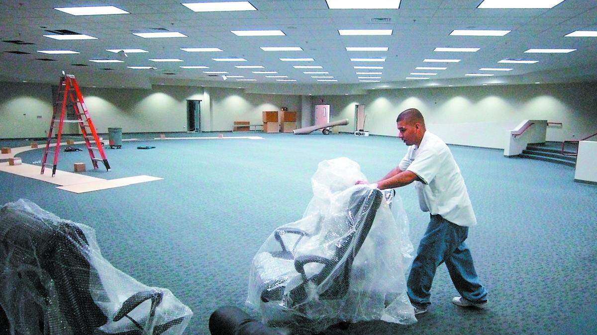 In November 2005, Victor Garcia delivers chairs to the relocated Atascadero City Hall chambers in the former home of the Creekside Lanes bowling alley. The city's renovation and use of the building is the crux of a dispute over federal disaster aid given to Atascadero in the wake of the 2003 San Simeon Earthquake.
