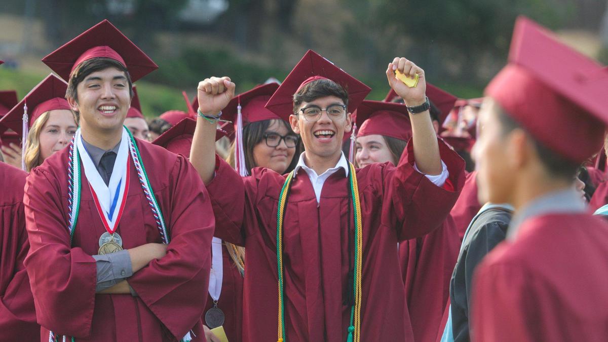 Miguel Muinz, left, and Omar Acevedo cheer as fellow graduates walk to their seats. Paso Robles High School conferred degrees on 383 graduates as the Class of 2023 attended the ceremony at War Memorial Stadium.