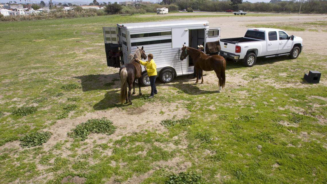 Glenda Charrette, left, and Lee Ashworth groom their horses in the equestrian staging area in Grover Beach in March 2014. They worry that a new hotel would not be compatible.