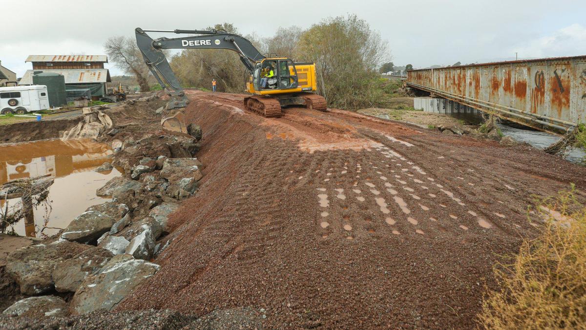 Work continues to patch the damaged levee at Arroyo Grande Creek in Oceano Jan 16, 2023, as a series of atmospheric river storms hit the coast.