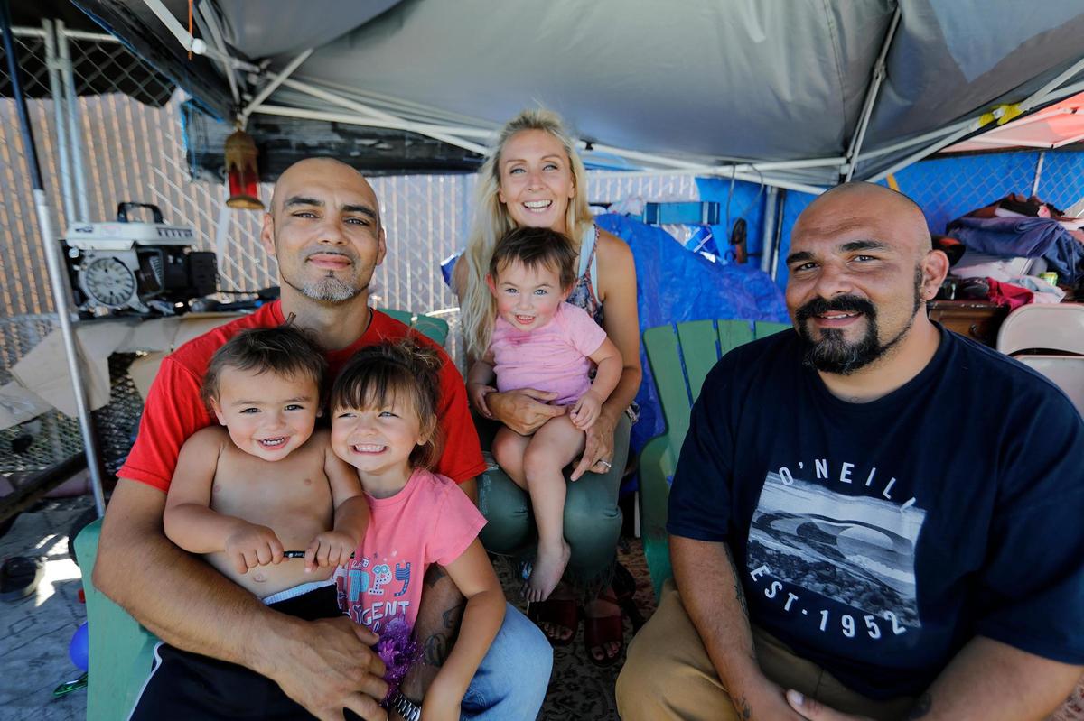 Mallory Mejia, center, a long-term resident at the Oklahoma Avenue Safe Parking Site, is the president of the new SLO County Local chapter of the California Homeless Union. Mejia, holding 1-year-old Leila, is pictured with husband Juan Mejia, holding Cain, 1, and Lorelei, 4, and Juan’s brother Alico Vetter.