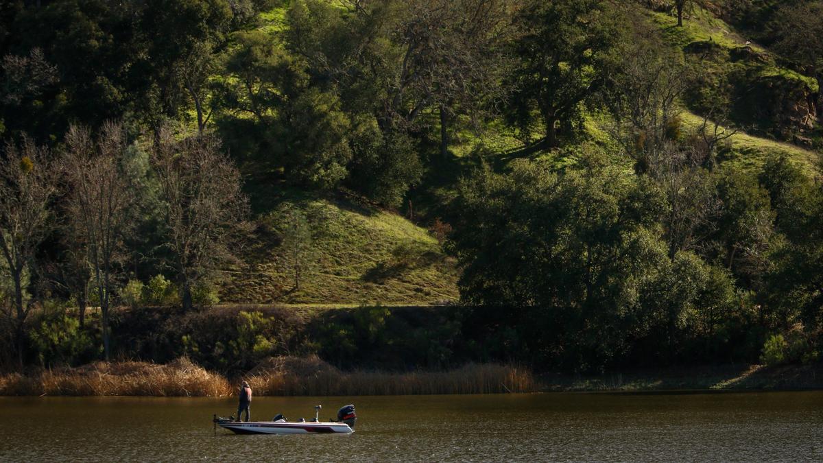 A fisherman waits for a bite at Santa Margarita Lake Recreational Area in 2019. The park in northern San Luis Obispo County remains open to visitors but campground reservations are suspended.