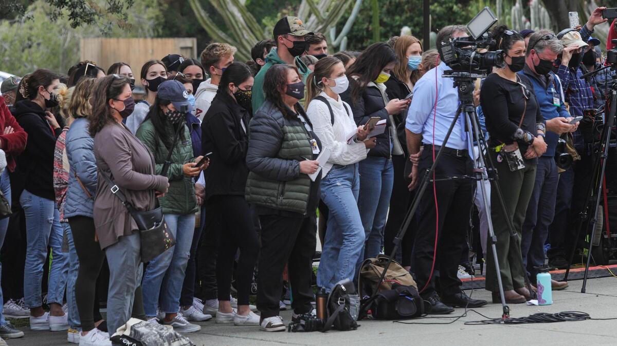 Members of the media listen and bystanders listen during a news conference Tuesday, April 13, 2021, at Cal Poly announcing the arrest of Paul Flores and Reuben Flores in connection with the disappearance of Kristin Smart.