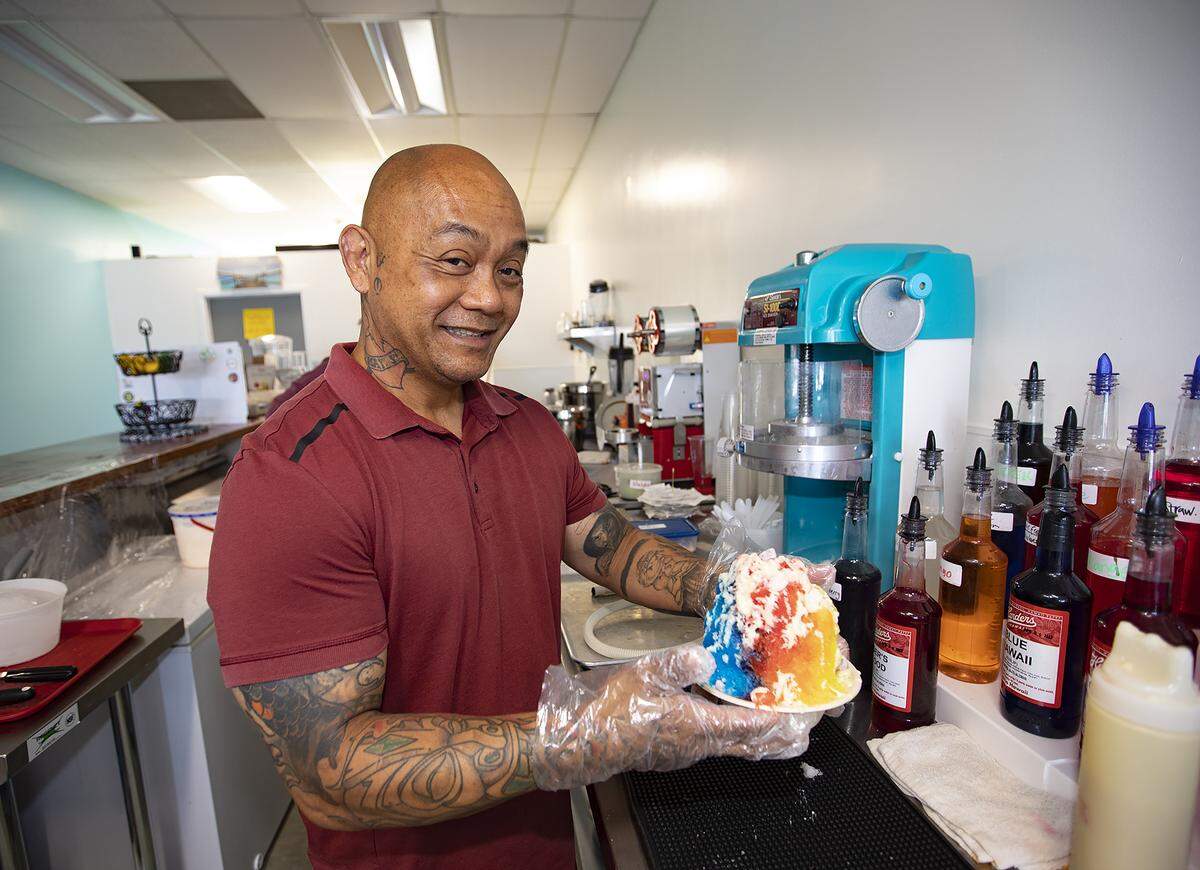 PCH Shave Ice & Boba co-owner Eric Cabrera holds up a Hawaiian-style shave ice creation. The Pismo Beach shop will hold its grand opening on Saturday, July 9, 2022.