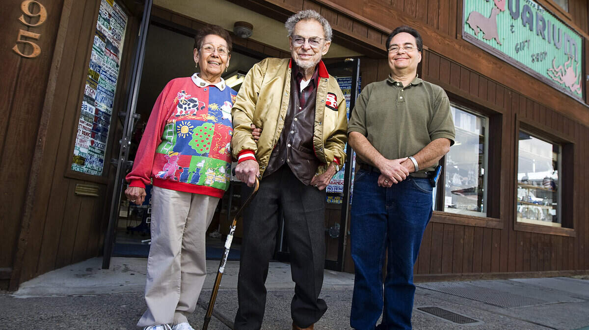Dean Tyler, center, opened the Morro Bay Aquarium in 1960. His wife, Bertha, says she “married into the aquarium.” Their grandson, John Alcorn, plans to take over the operation of the aquarium when the Tylers retire.