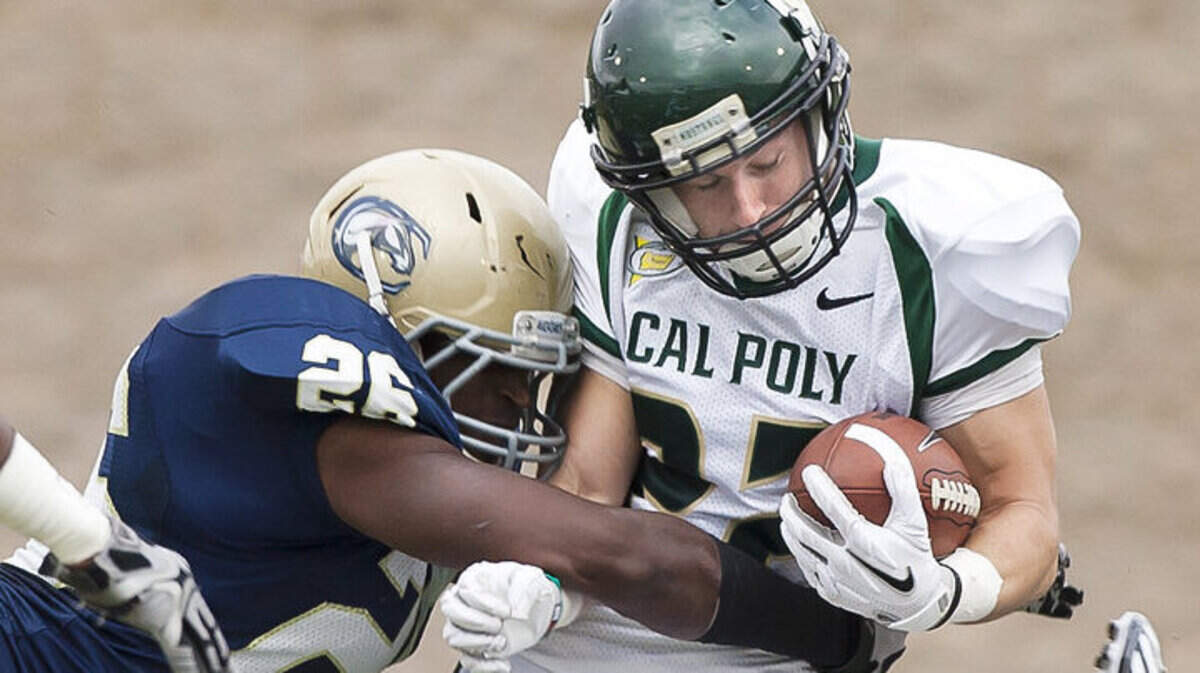 Cal Poly's Chris Nicholls is hit hard by UC Davis' Kevyn Lewis during a Big West Conference match-up at Jim Sochor Field in Davis, Calif.
Nick Lucero 11/05/2011