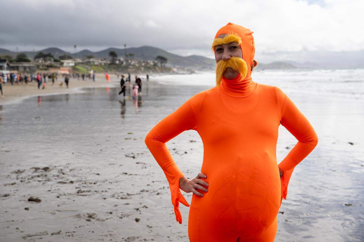 Diver Erin Culp poses for a photo before running into the ocean during the annual Carlin Soulé Memorial Polar Bear Dip on Thursday, Jan. 1, 2026. The 46th annual dip drew thousands of divers even amid overcast and rainy weather.