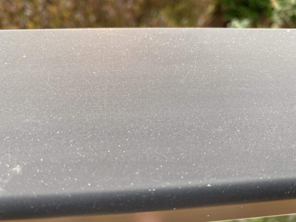Ash clings to a deck rail in Morro Bay on Wednesday, Aug. 19, 2020.