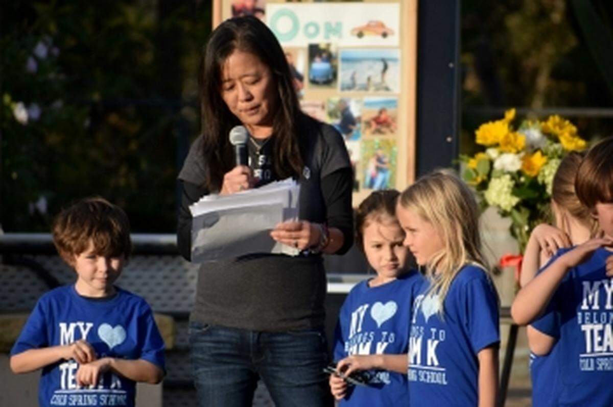 Cold Spring School kindergarten teacher Lisa Ishikawa reads a tribute to 6-year-old Peerawat “Pasta” Sutthithepa, a student of hers who was one of four family members to perish in the debris flows.