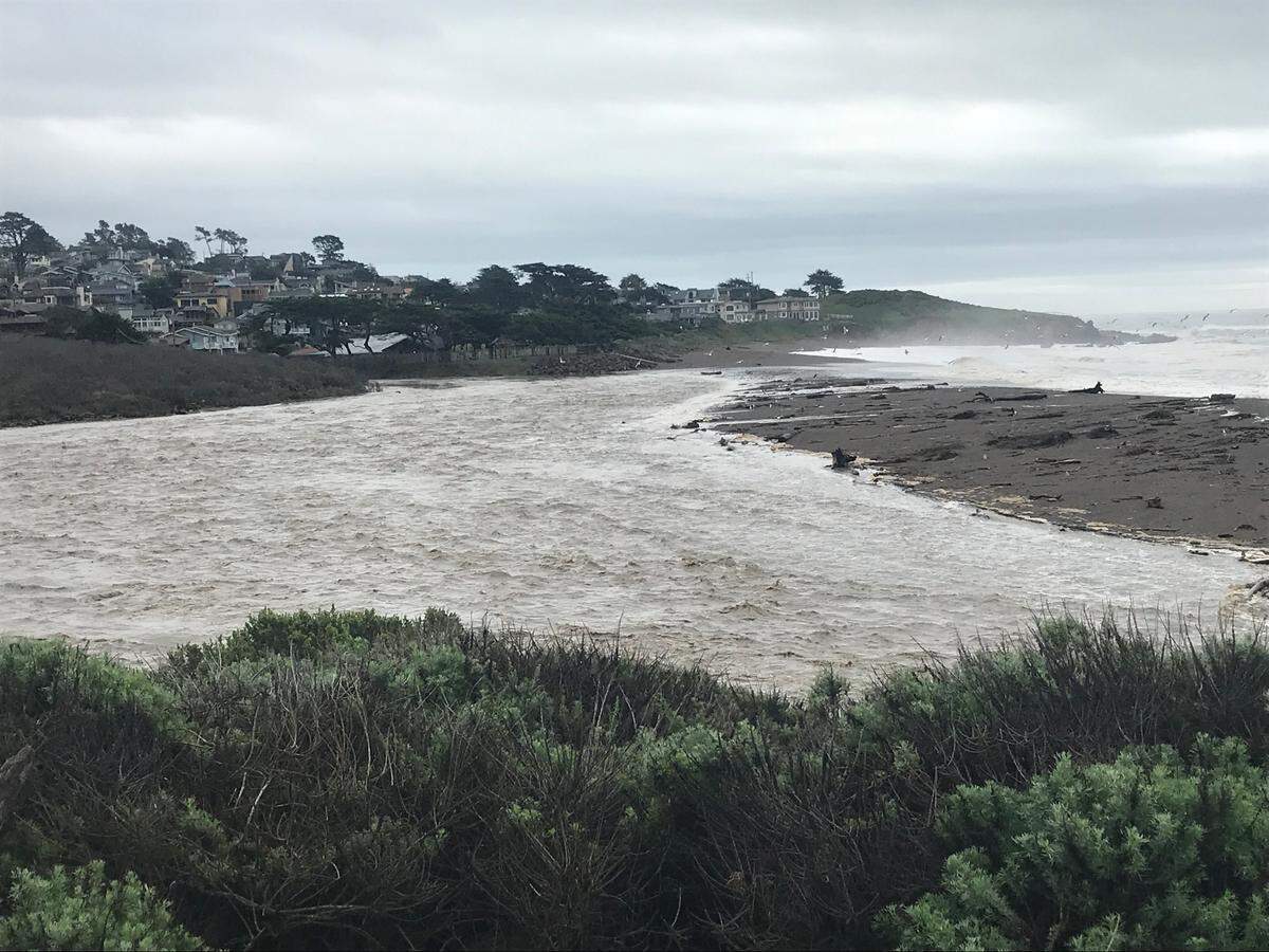 The mouth of Santa Rosa Creek in Cambria is swollen with rain water on Sunday, Jan. 8, 2023.