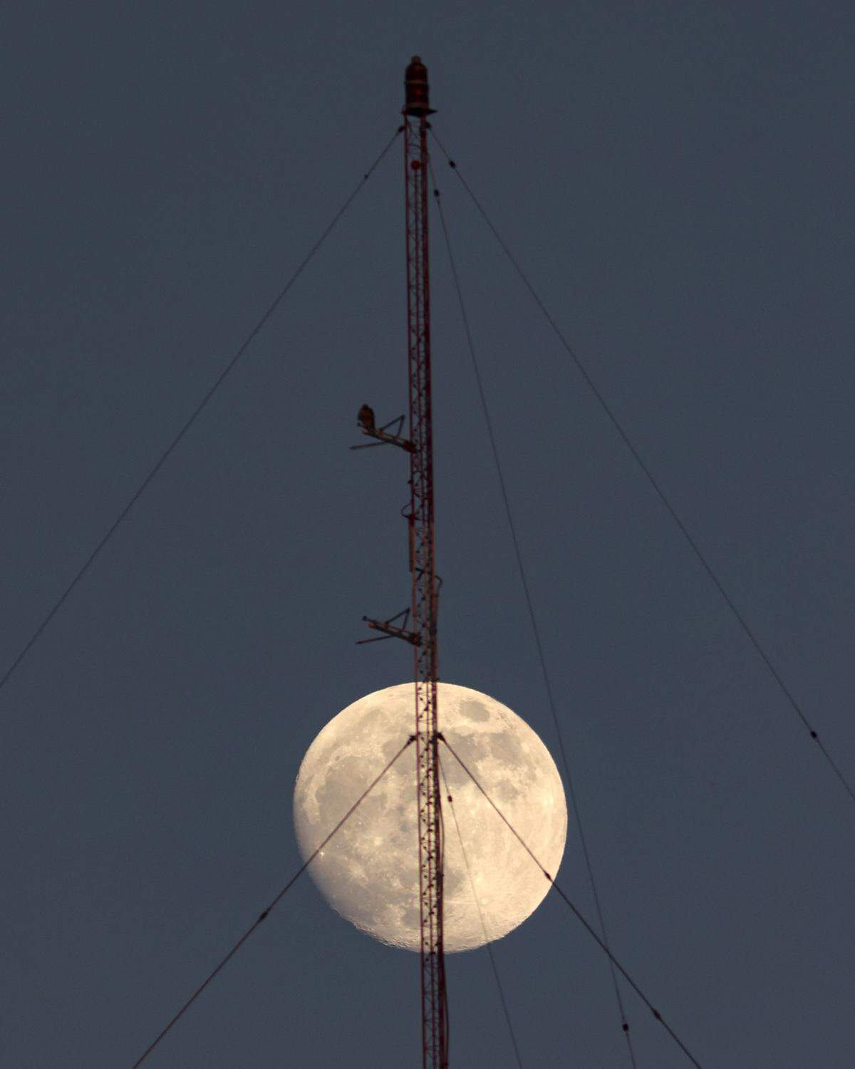 A not quite supermoon rises behind a radio antenna on the South Street Hill in San Luis Obispo on Tuesday, June 22.