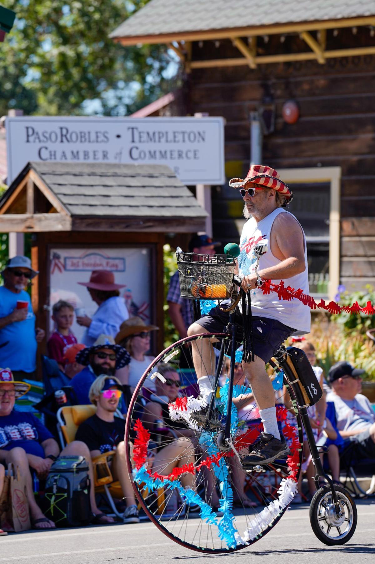 A penny farthing rolls down the street in the Templeton Fourth of July Parade Thursday, July 4, 2024. The parade featured dozens of floats and acts, including classic cars, marching bands and appearances by local law enforcement and fire services.