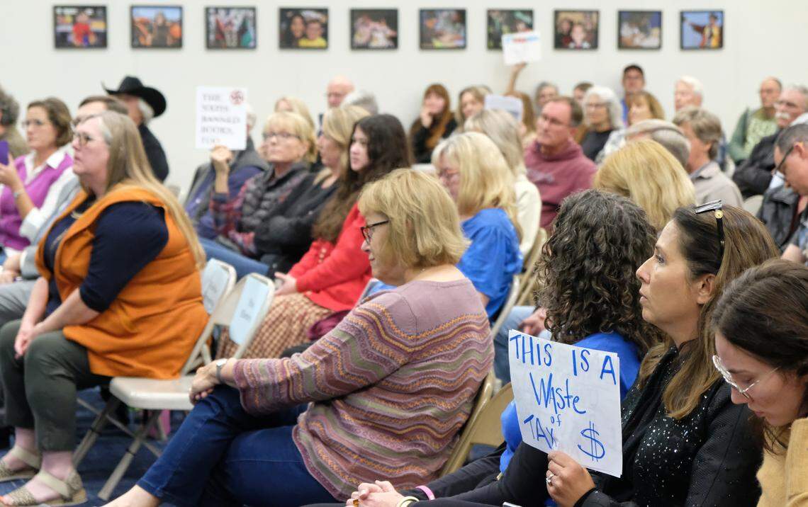 Community members hold signs at a Lucia Mar school board meeting on Nov. 18, 2025, where the books “Gender Queer” and “Push” came under fire. The board voted to keep the books in the Arroyo Grande High School library.