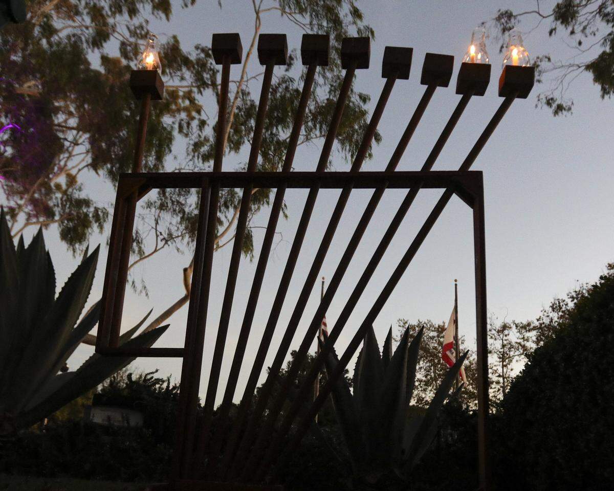 About a dozen people gathered in front of Mission San Luis Obispo to light the menorah on the second night of Hanukkah on Dec. 15, 2025.