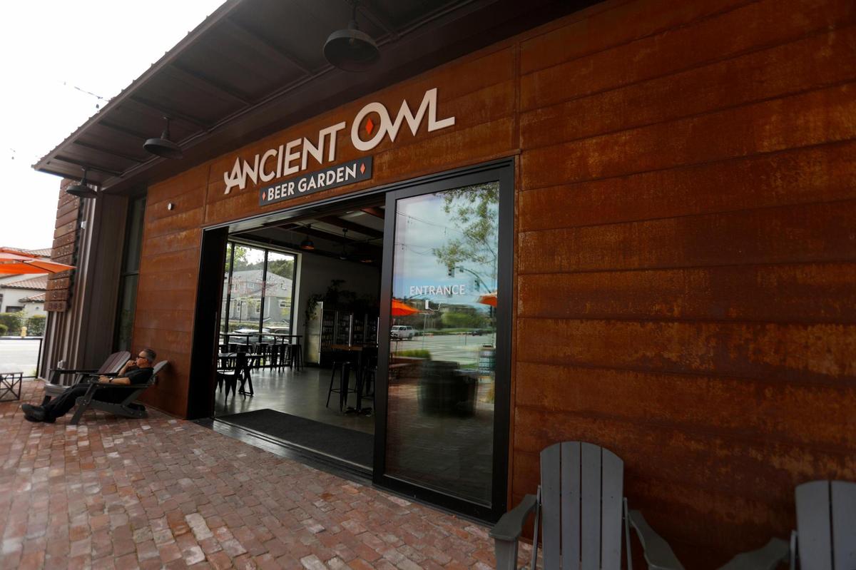 People lounge in front a large brick patio and picnic tables at the Ancient Owl Beer Garden. That’s the vision and now reality behind Duncan Alley — an up-and-coming makers marketplace in SLO’s LoBro neighborhood.