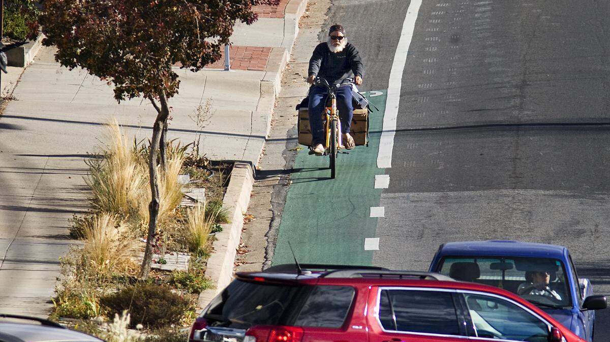 A cyclist heads toward the intersection of California Boulevard and Monterey Street in San Luis Obispo.