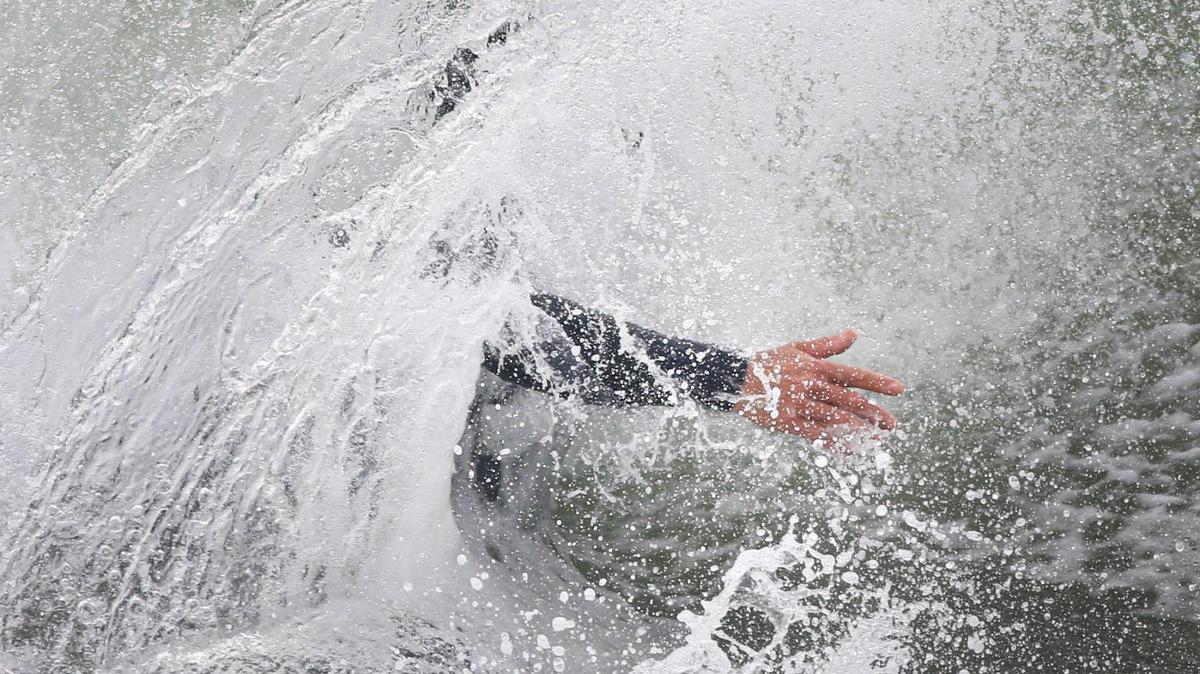 Waves crash over a surfer in Cayucos.