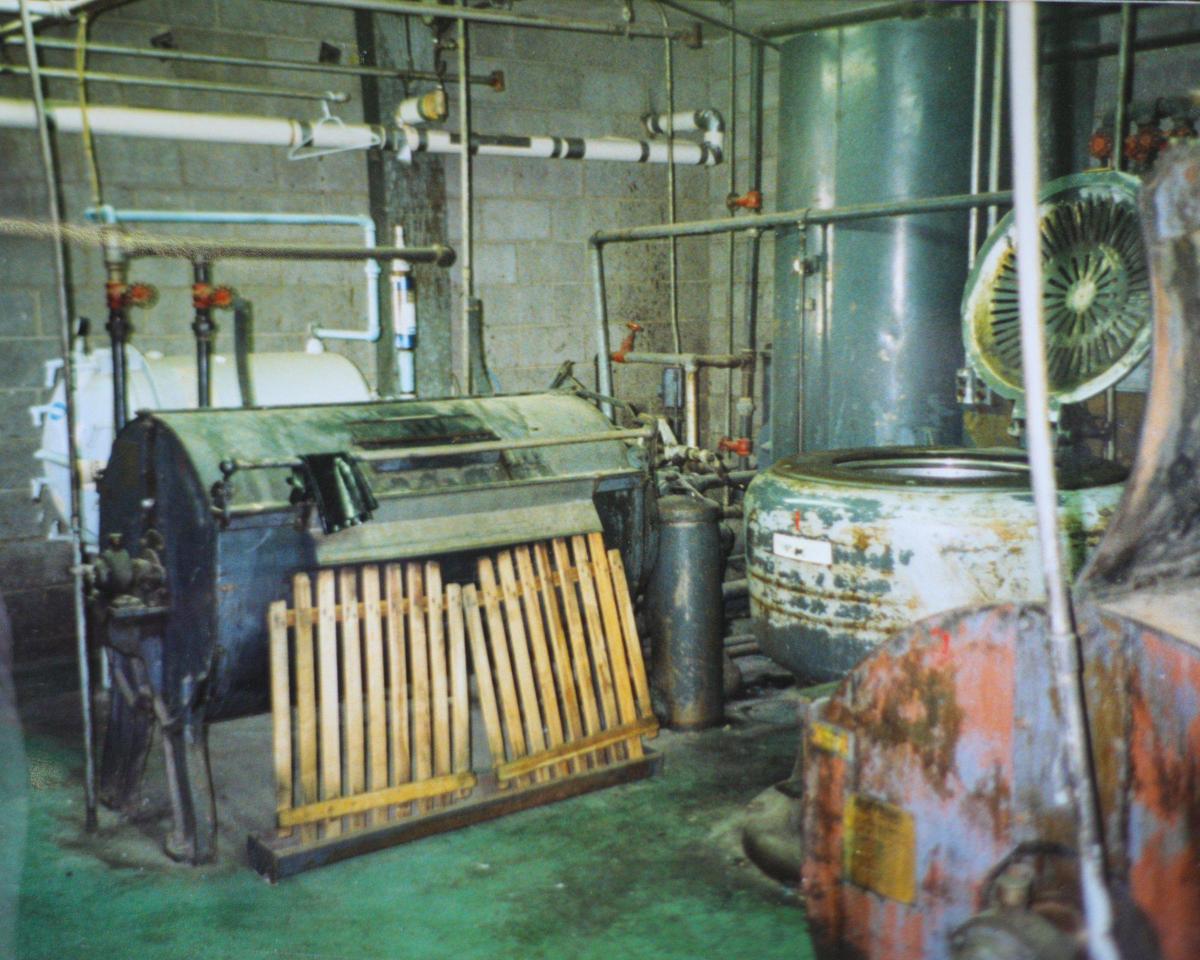 Old dry cleaning equipment circa 1950 when Paul’s Dry Cleaner’s was built.The old equipment vented to the atmosphere. It was replaced by new machines that have a closed system that recaptures and recycle cleaning chemicals.