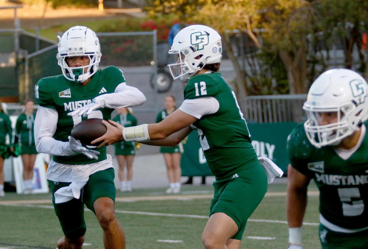 Cal Poly quarterBack Jackson Akins hands the ball off to Michael Brisco. Cal Poly beat Sacramento State 26-23 in a college football game at Mustang Memorial Field on Nov. 16, 2024.