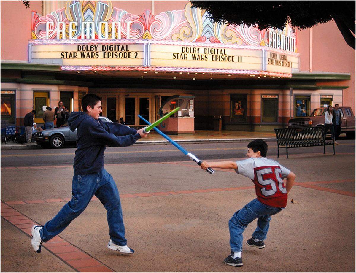 Steve Jones, 17, and Michael Anaya, 11, duel with their lightsabers before a sold-out midnight show of "Star Wars: Episode 2" at the Fremont Theater in San Luis Obispo in May 2002.