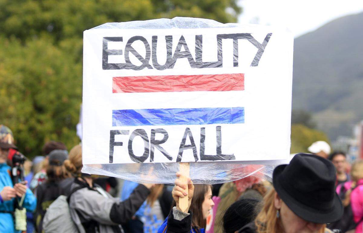A protester holds a sign at the San Luis Obispo Women’s March in January 2017.