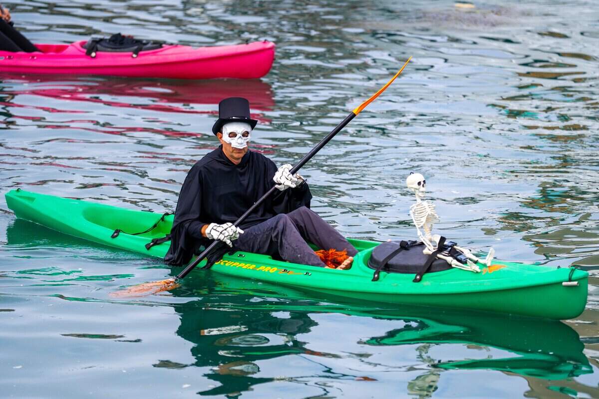 A skeleton man paddles a kayak at the 2025 Witches Paddle in Morro Bay on Saturday, Oct. 25, 2025. The 13th annual paddle attracted hundreds of witches and creatures of the night taking to the watter on paddleboards, kayaks and other small craft.