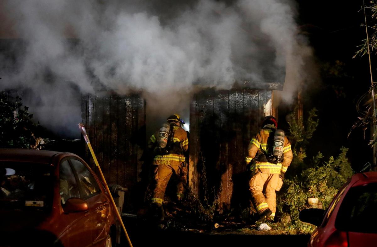 Firefighters enter the building after knocking down the flames. Cal Fire crews are responding to reports of a fully-engaged house fire on 7th Street in Los Osos.