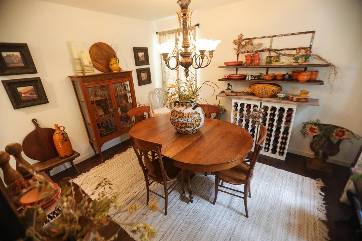 The dining room of Ann Tye’s charming Cambria cottage mixes family heirlooms and vintage furniture.