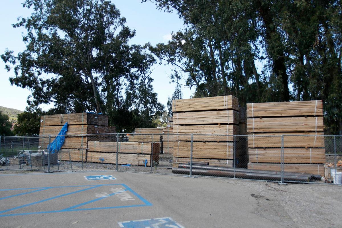 Bundles of wood are piled on the side of the building at 1150 Laurel Lane in San Luis Obispo, whose tenants have been told they have to vacate due to unsafe construction conditions. This includes the popular Bang the Drum brewery and SLO City Church, both of which moved into the partially completed building during the COVID pandemic.