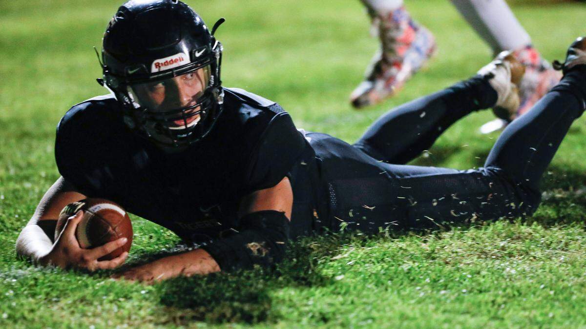 Emilio Corona dives for a touchdown. Eighth-seeded San Luis Obispo hosted ninth-seeded South (6-4) of Bakersfield on Friday in the Division 3 bracket.