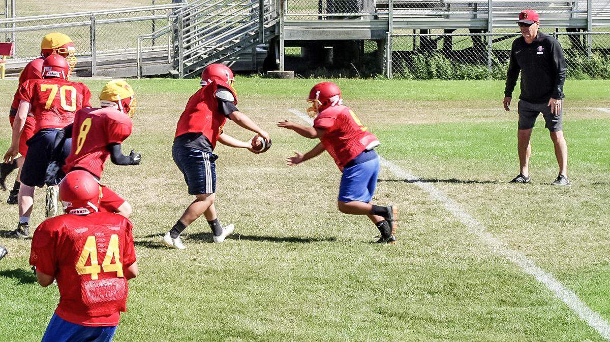 At Coast Union’s practice on Thursday, Aug. 8, quarterback Emany Plasencia is in the process of either faking a handoff to Angel Reyes or actually giving the running back the ball. Plasencia has an option to throw a quick pass to Emi Pena, No. 44, in the foreground.