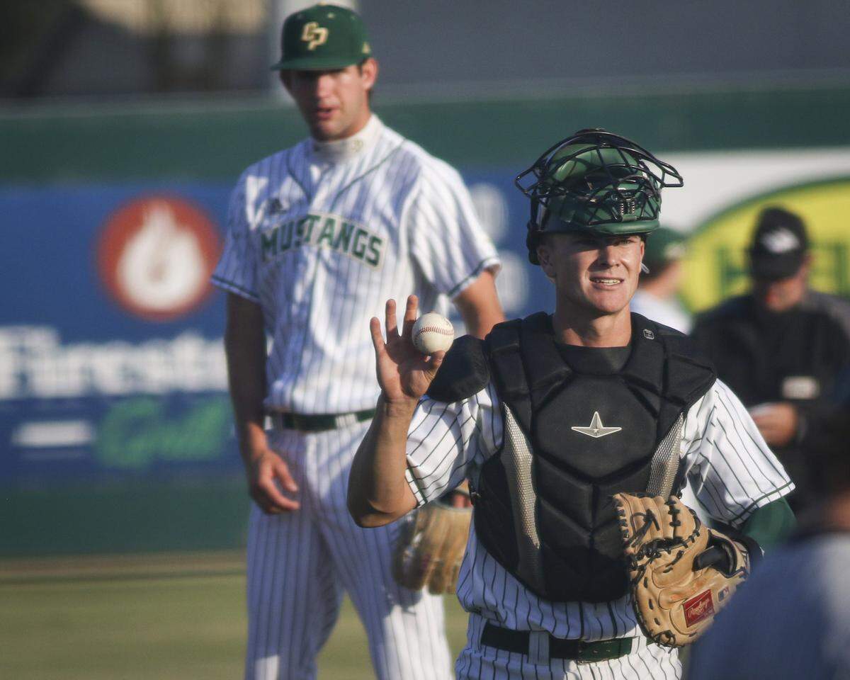 Ryan Tayman asks for a new ball after a conference at the mound with Griffin Naess. Cal Poly beat Long Beach State 11-3 on May 14, 2026. 