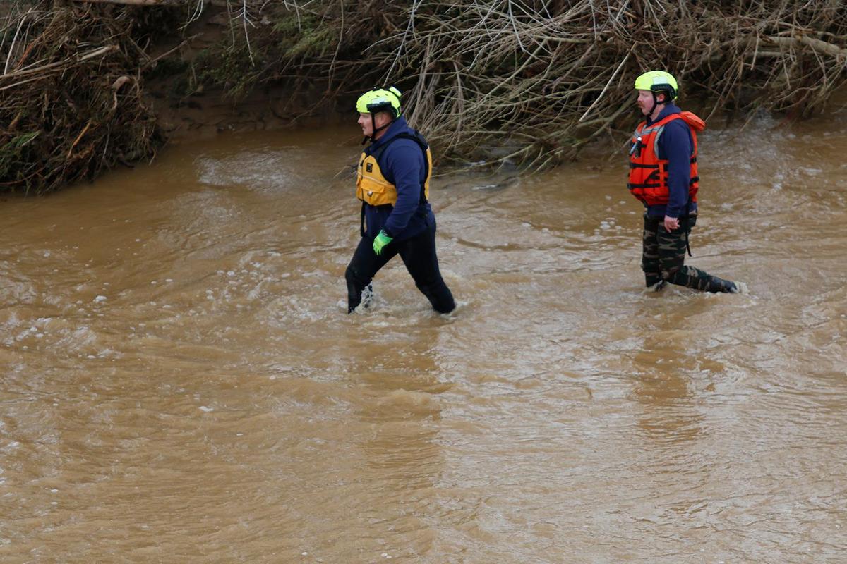 Searchers check through floodwaters and debris for any sign of 5-year-old Kyle Doan on Wednesday, Jan. 11, 2023, two days after he disappeared in swollen San Marcos Creek near San Miguel.