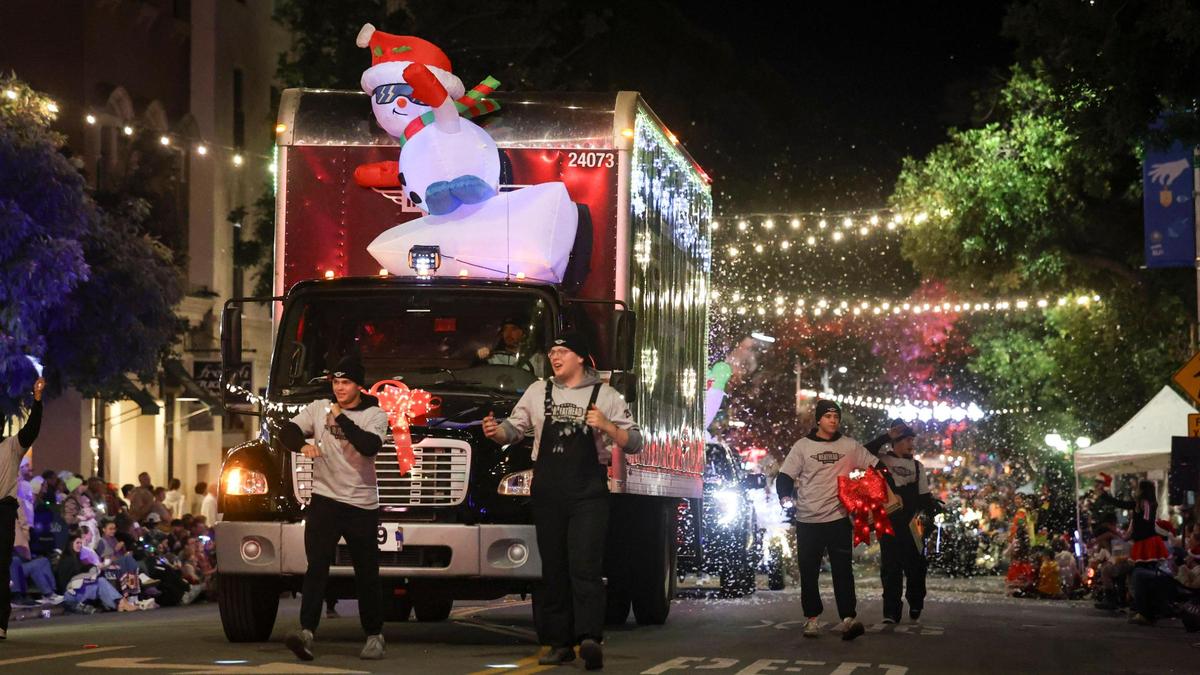 Meathead Movers blew snow out of the back of a moving truck. Unseasonably warm weather encouraged a large crowd to attend the 48th annual downtown Holiday Parade. on Dec. 6, 2024.