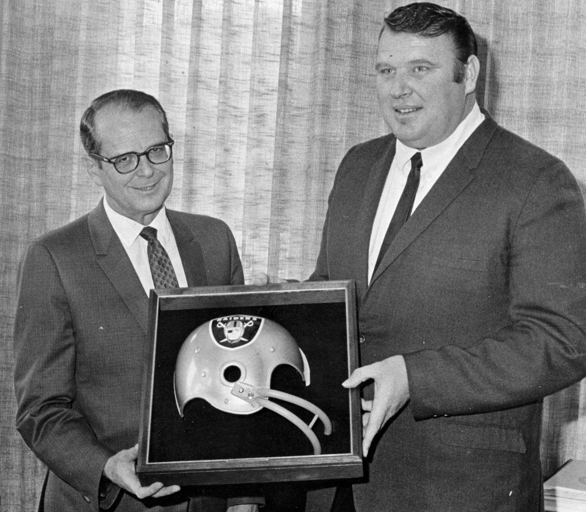 Cal Poly President Robert E. Kennedy accepts a plaque from John Madden on May 24, 1969, after Madden became the new head coach of the Oakland Raiders. At age 33, he was the youngest head coach in pro football. Madden earned bachelor’s and master’s degrees from Cal Poly.
