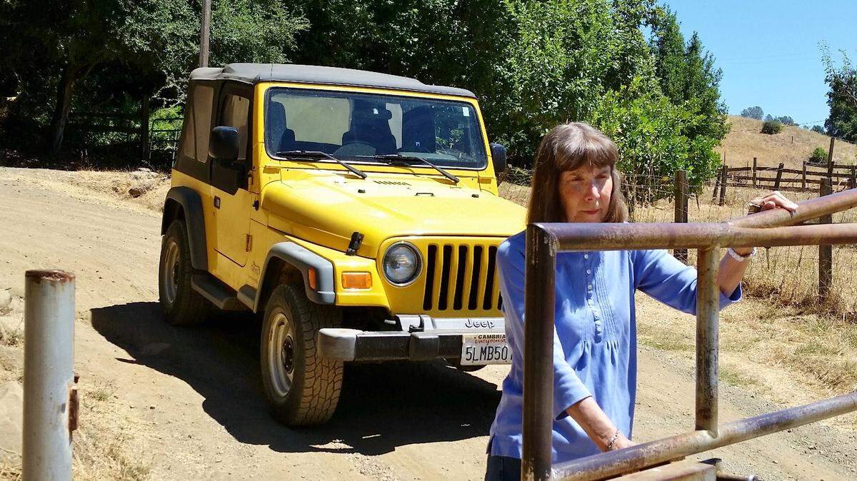 Cambrian Mountain Musings columnist Marcia Rhoades opens a backcountry gate near her home in the mountains above Cambria.