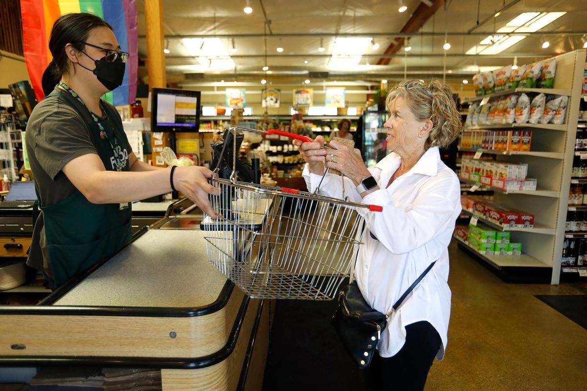 Cheryl Burcheri hands her grocery basket to team leader Clay Kim after she paid for her grocerises. The SLO Food Co-op (formerly known as the San Luis Obispo Natural Foods Co-op) has been serving the San Luis Obispo community since 1975 — so it’s been around for about 50 years.