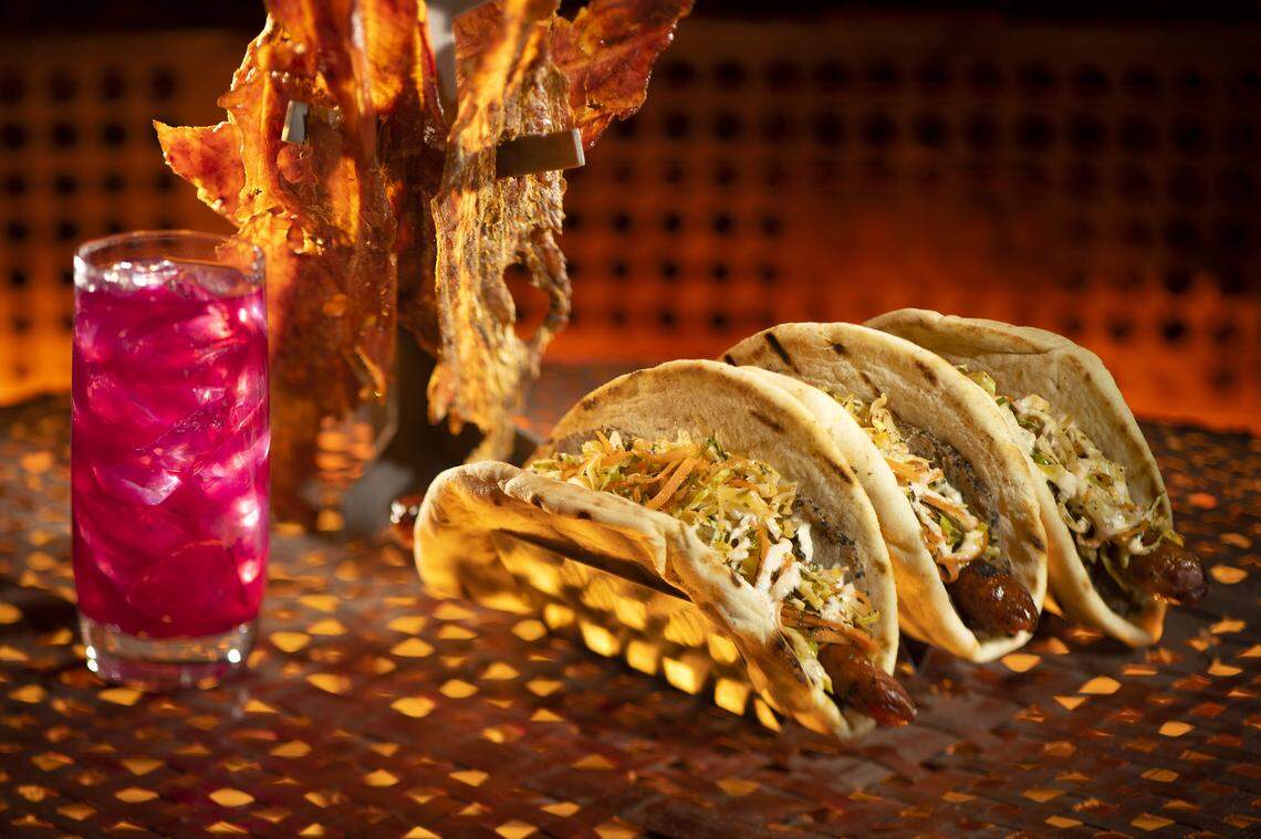 Pictured here, left to right, are the Meiloorun Juice, the Turkey Jerky and the Ronto Wrap filled with spiced grilled sausage and roasted pork found at Ronto Roasters, located in the Black Spire Outpost market inside Star Wars: Galaxy’s Edge at Disneyland.