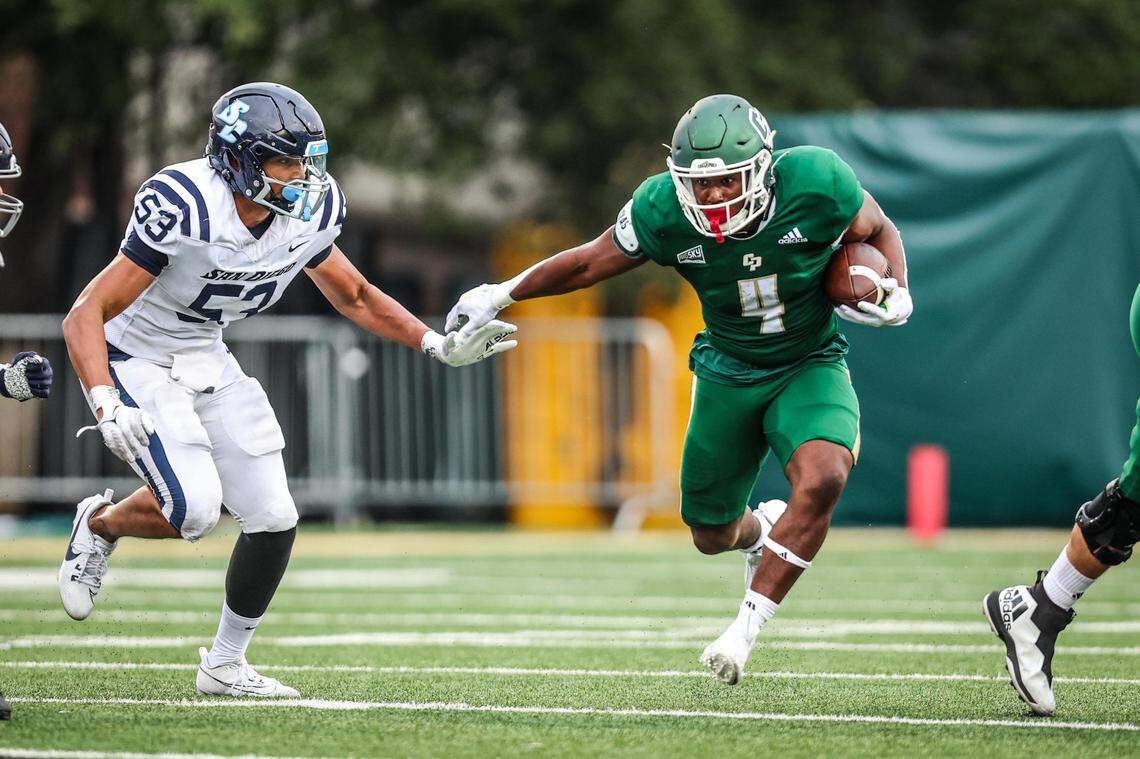 Cal Poly running back Mark Biggins (4) carries the ball against the University of San Diego on Sept. 1, 2023, in the Mustangs’ home opener.