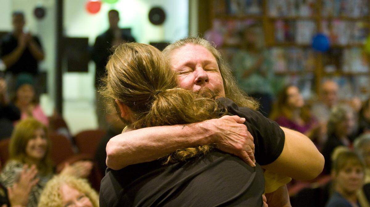 Gail Schnoor hugs her son, Fritz Schnoor, who completed the county's Behavioral Health Treatment Court program Friday, June 13.