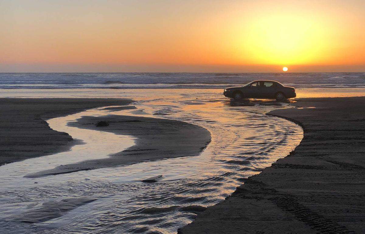 A car crosses Arroyo Grande Creek at the Oceano Dunes State Vehicular Recreation Area on March 21, 2021. The Coastal Commission’s historic decision bans vehicles from crossing the creek when it’s flowing, which would cut off access to the majority of the park’s off-highway use.