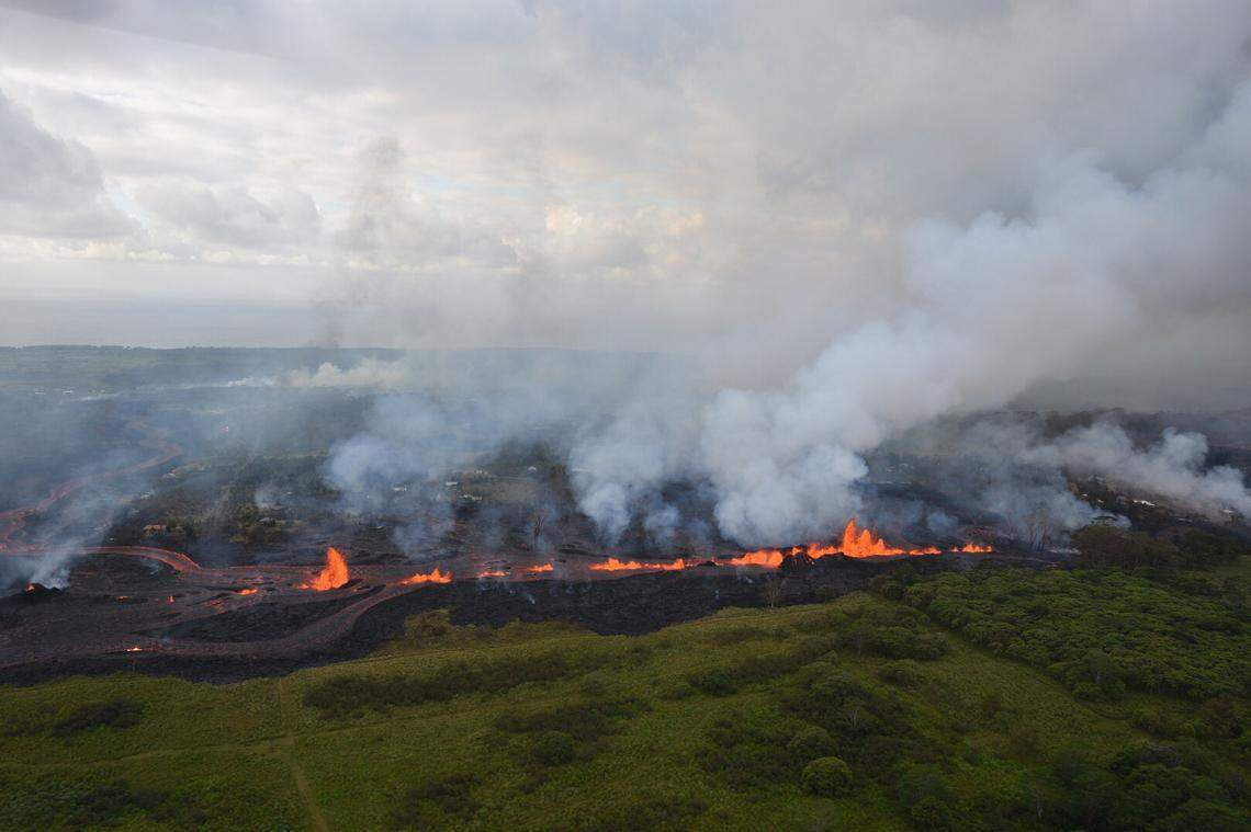 This May 19, 2018 aerial photo released by the U.S. Geological Survey shows lava fountains from Fissure 20 in Kilauea Volcano's lower East Rift Zone in Pahoa, Hawaii. Kilauea volcano began erupting more than two weeks ago and has burned dozens of homes, forced people to flee and shot up plumes of steam from its summit that led officials to distribute face masks to protect against ash particles.