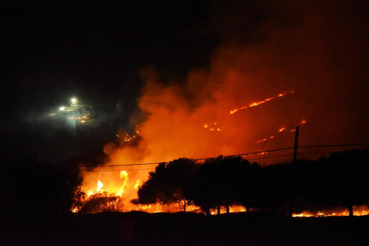 Flames burn on a hillside Monday night.