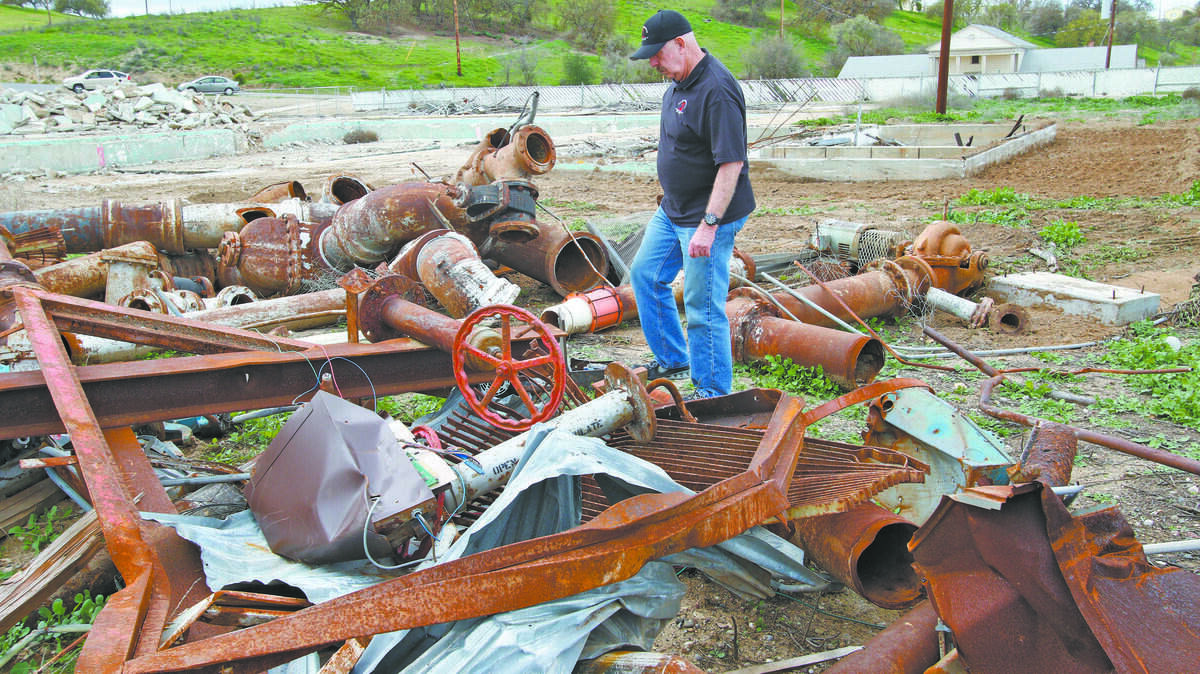Gary McMaster walks through the scrap yard filled with pool pipes at Camp Roberts.