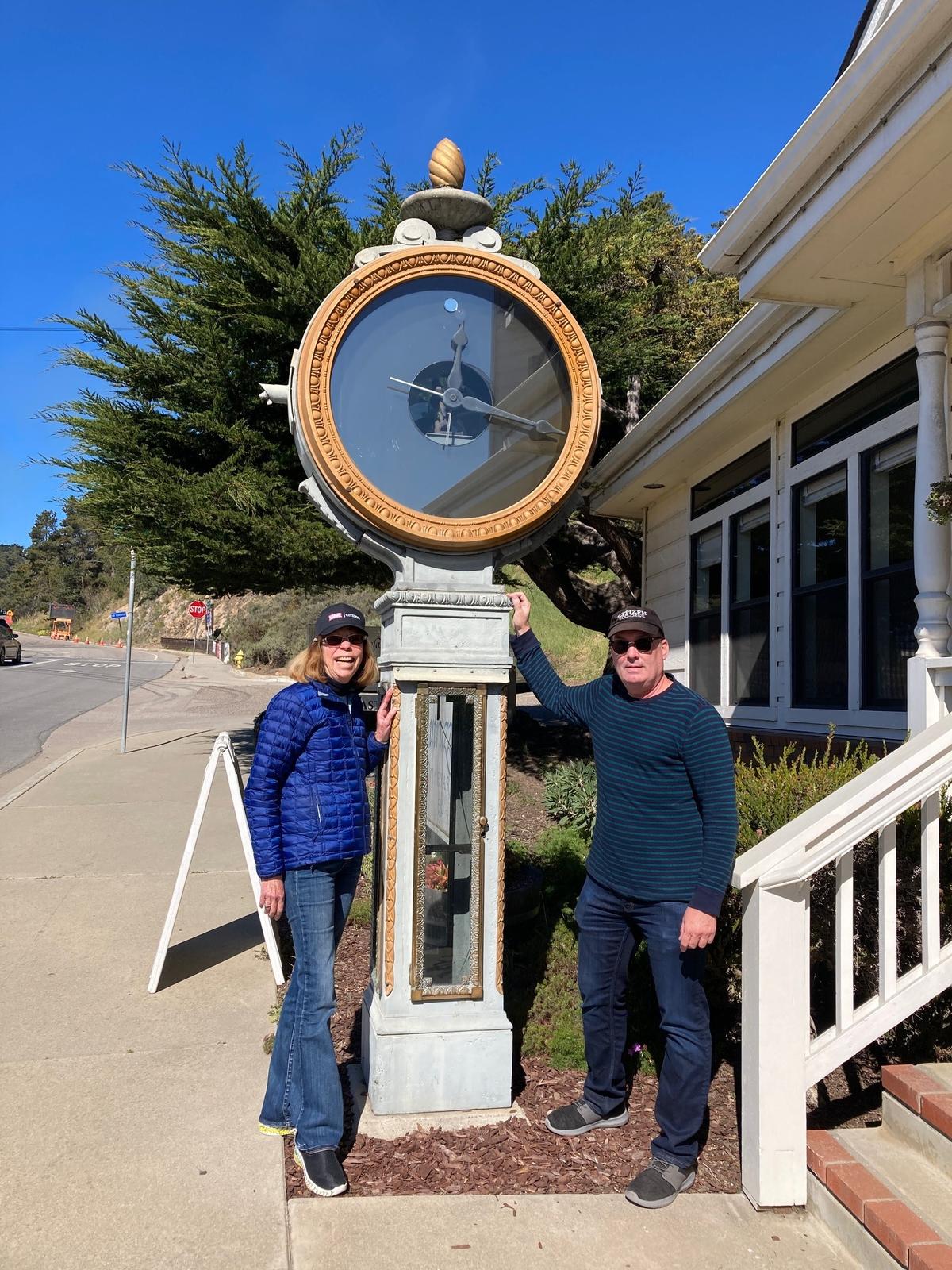 Sue Forman, owner of the Once Upon a Tyme clock/doll shop in Cambria, and the store’s horologist, Phillip Ehorn, stand one last time by the tall town clock that’s stood near the shop since 1991.