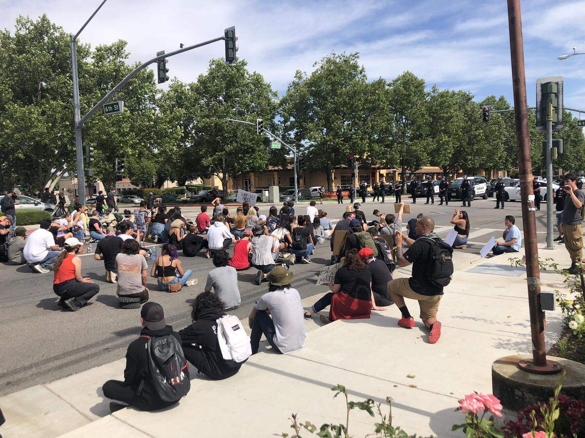 Protesters observe a moment of silence for George Floyd, who died in police custody in Minneapolis, during a Black Lives Matter march in Paso Robles on Tuesday, June 2, 2020.